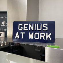 GENIUS AT WORK metal sign Light Cream text on Navy Blue background