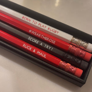 Set of 4 coloured pencils in red, white and black with embossed phrases related to the game of rugby