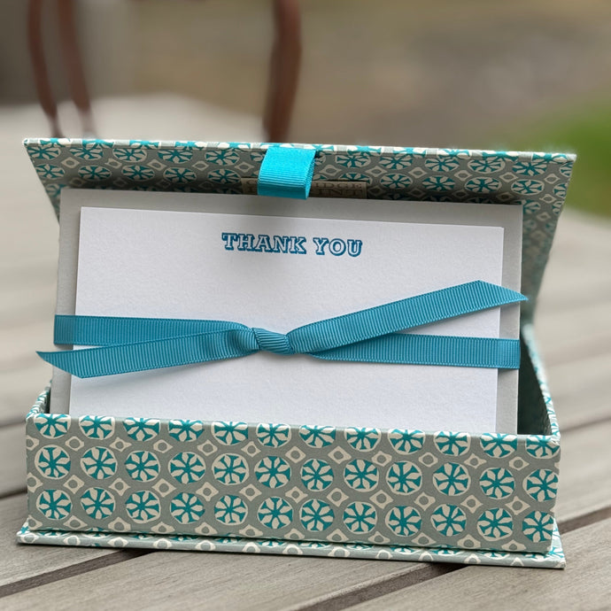 Post card box in Sea Urchin Aquamarine colour contains a set of notecards printed with the text Thank You in Neon blue