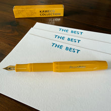 Yellow fountain pen (Honey) alongside a set of notecards with the text THE BEST at the header
