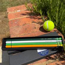 Set of 4 coloured pencils with various text on including Game Set Match! 