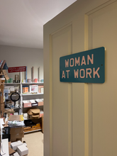 WOMAN AT WORK sign
